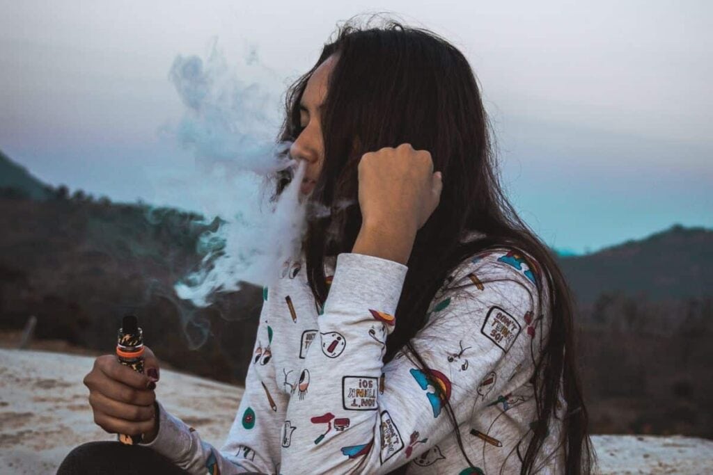 A girl vaping Delta 8 THC