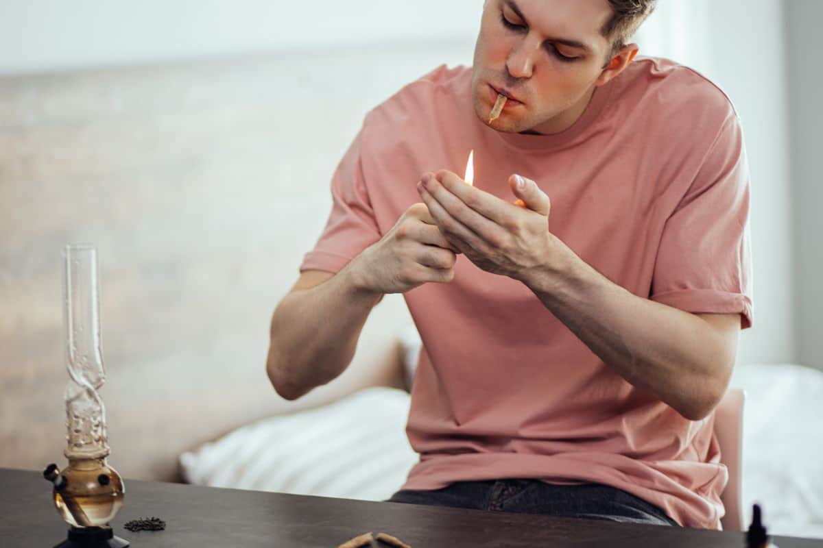 A guy smoking various weed products A guy smoking various weed products