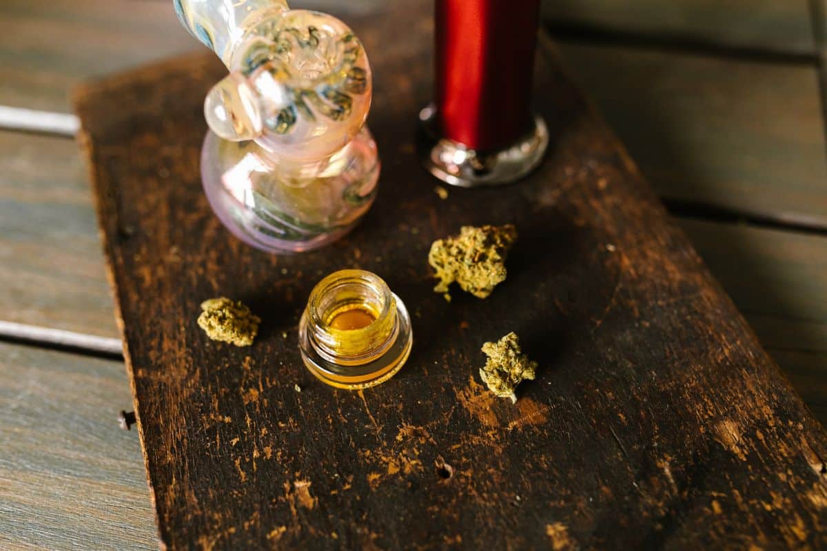 On a table, a wine glass chills next to a dab pen for innovative dabbing