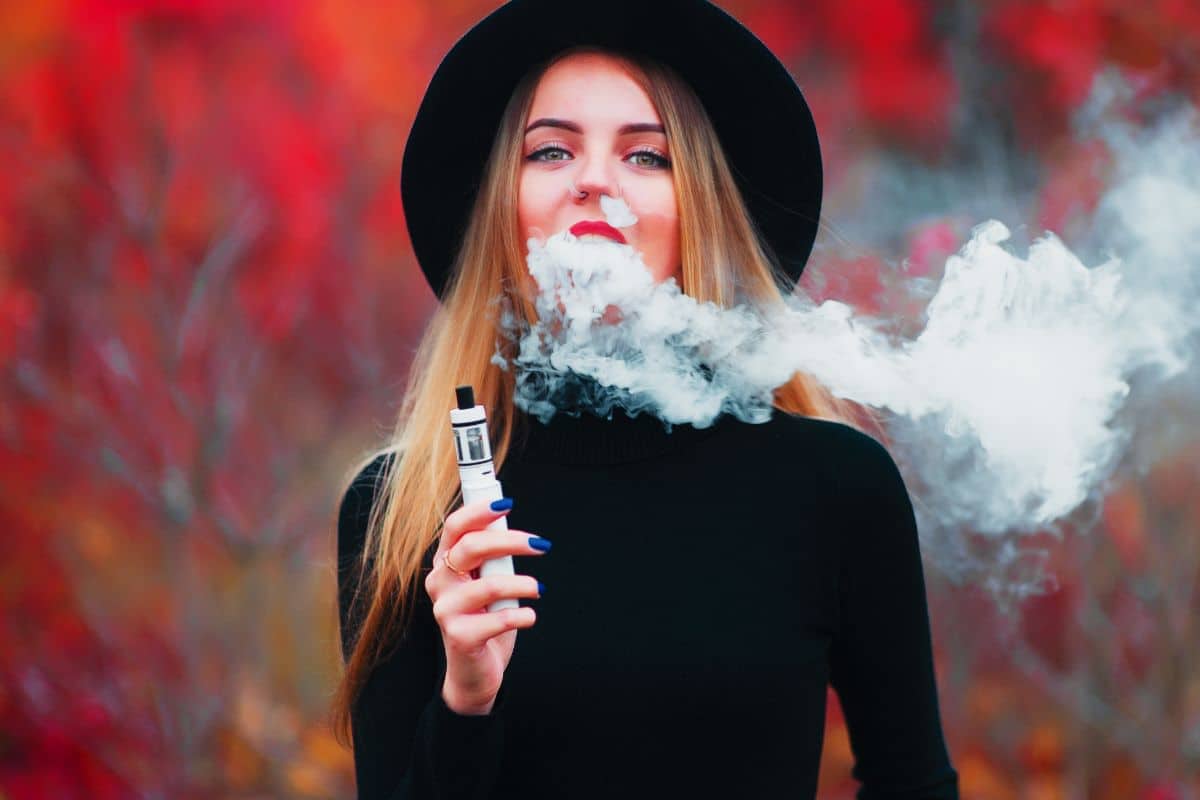 A lady vaping delta 8 THC outdoors A lady vaping delta 8 THC outdoors