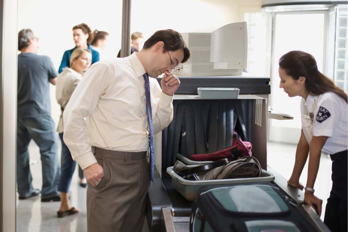 A man getting checked at the airport A man getting checked at the airport