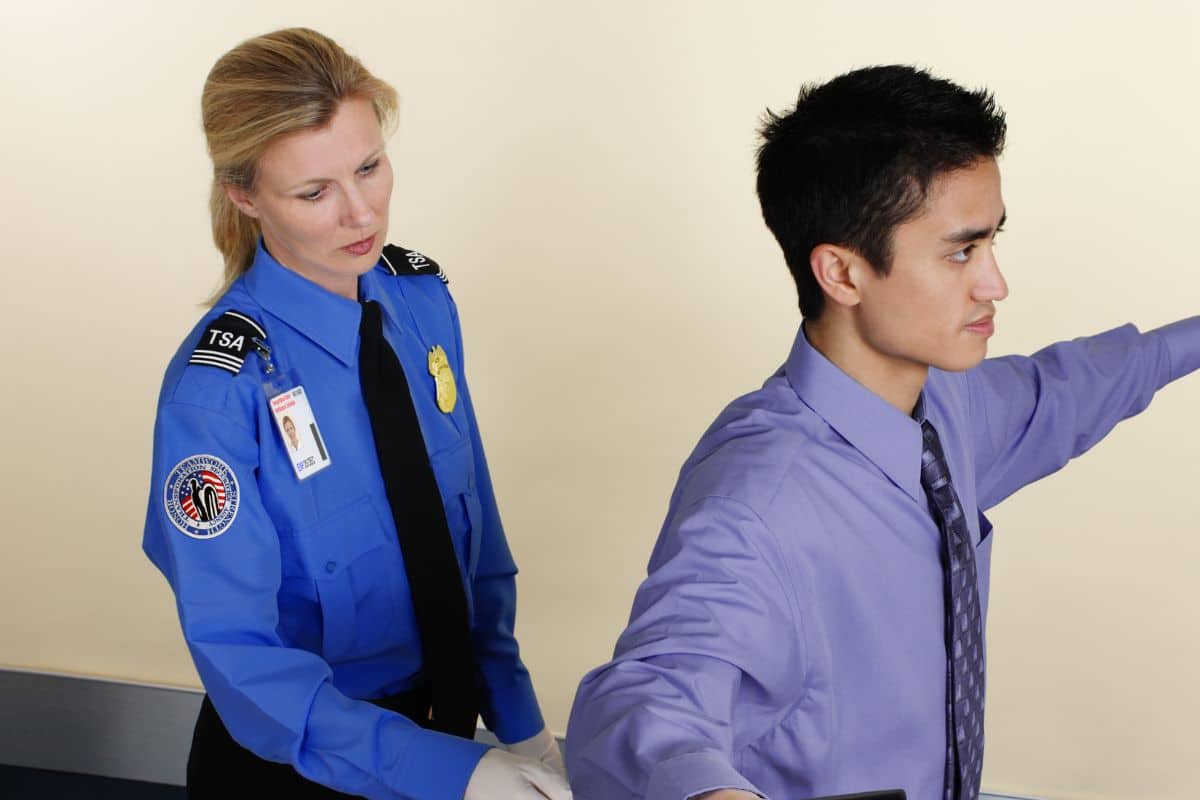 A TSA official checking for cbd products at the airport