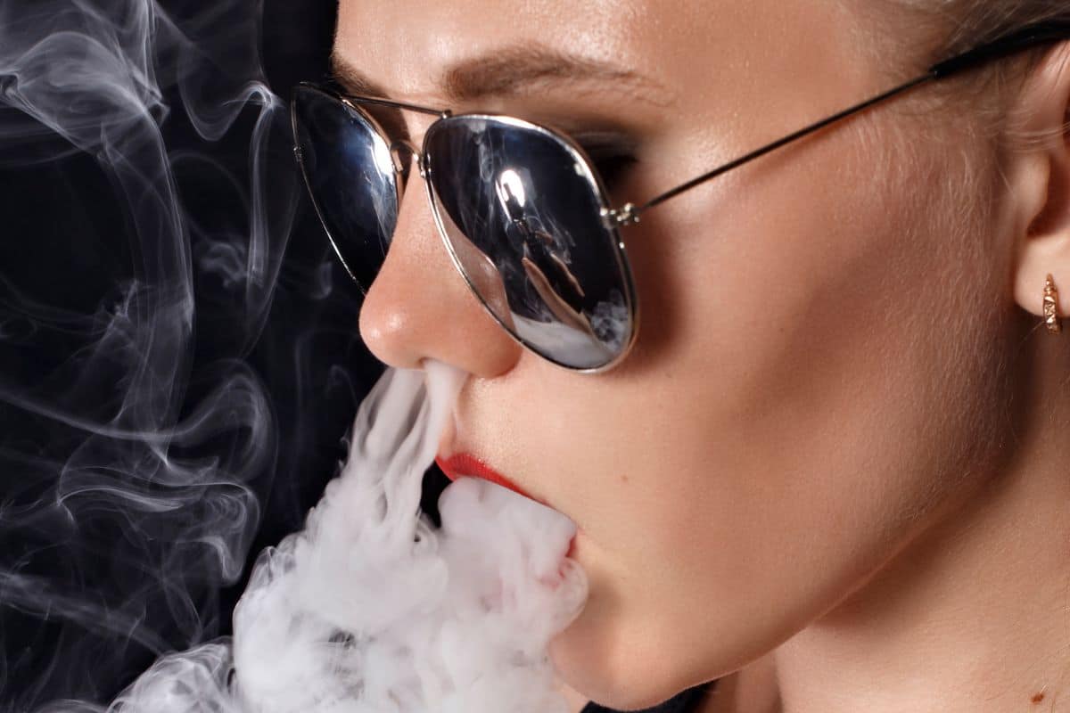 A lady trying french inhale weed smoking trick A lady trying french inhale weed smoking trick