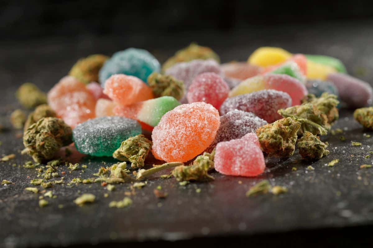 A heap of CBD gummies on a dark background, showcasing indica gummies.