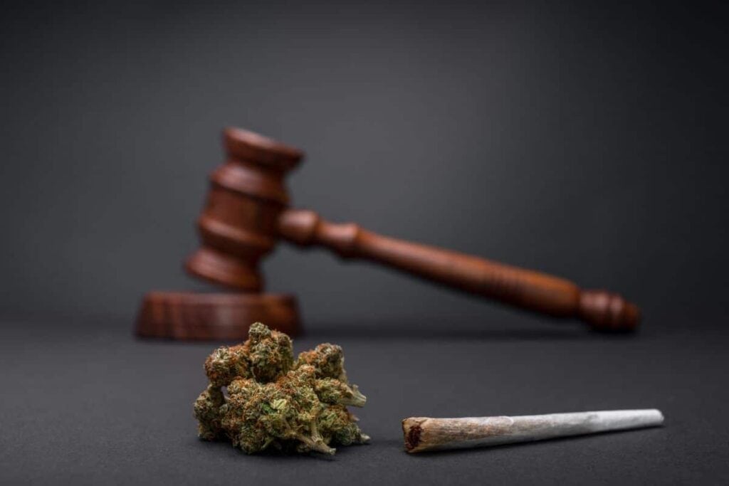 A gavel on a black background, representing the legal aspect of Marijuana in Rhode Island.