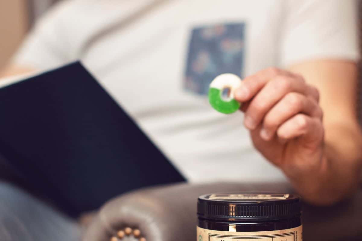 A guy eating cbd gummies while working on a laptop