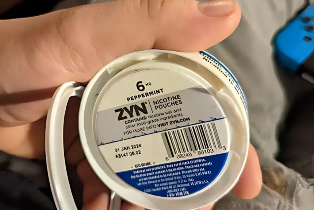 A person showing empty compartment of
zyn nicotine pack