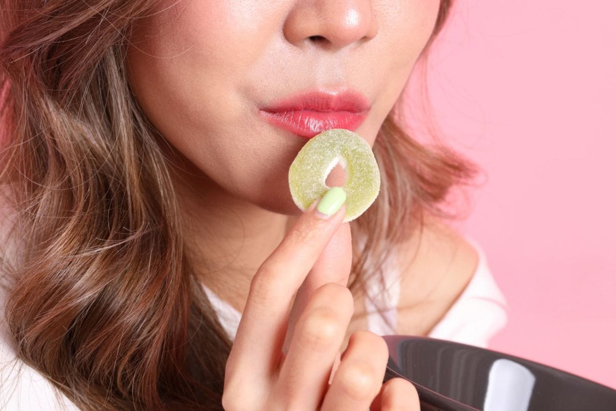 A lady eating live rosin gummies
