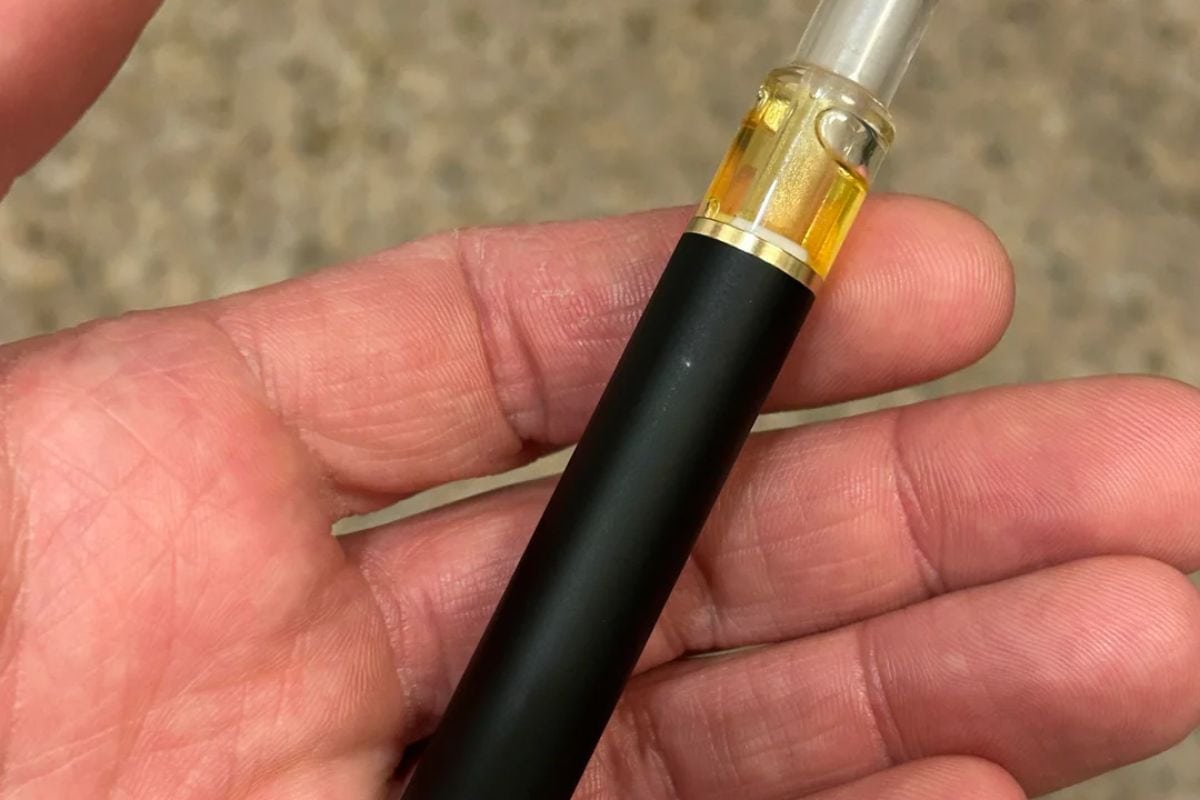 A person holding clogged disposable vape