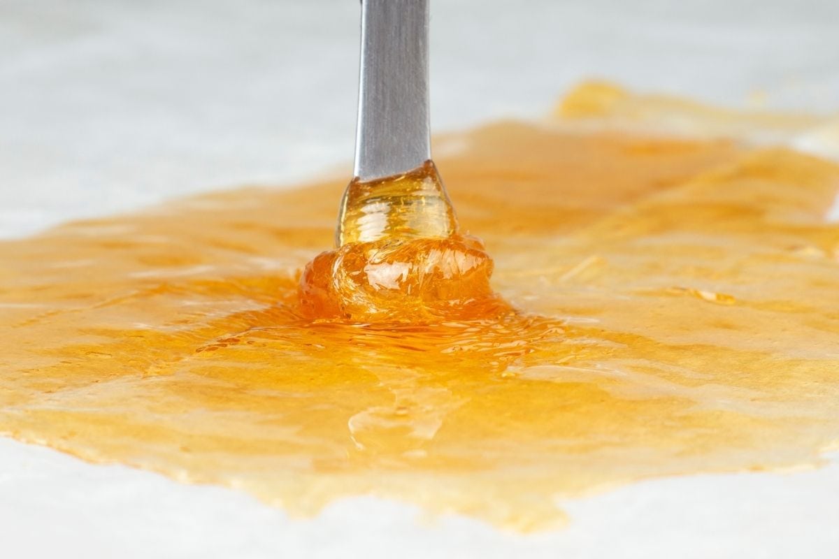 A close-up view of cannabis liquid dab is shown in the image