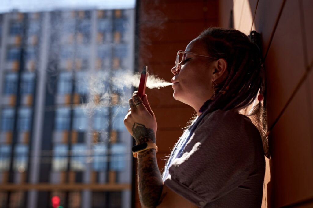 A lady vaping muha meds vape to get high