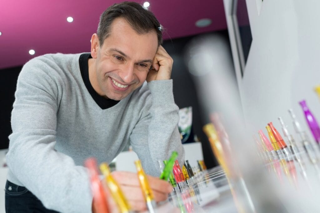 A person buying vape cartridges from a shop